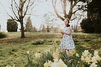 Girl with Down Syndrome picking flowers in a park