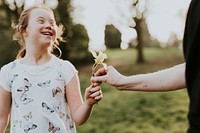 Down syndrome girl receiving flower