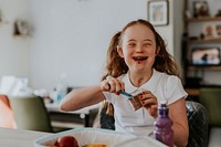 Girl with Down Syndrome eating chocolate pudding