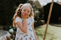 Cheerful girl with Down Syndrome playing in the backyard