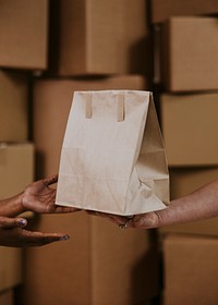 Food delivery man handing bag to customer