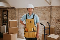 Construction worker wearing handyman apron with tools