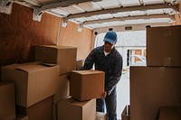 Moving worker unloading boxes from truck