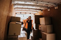 Moving worker unloading boxes from truck