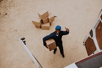 Removal service worker unloading box from the van