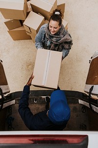 Removal service worker handing box to customer