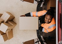 Removal service worker unloading box from the van