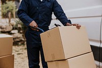 Worker unloading boxes, removal service job