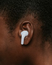 African woman wearing wireless earphones closeup photo