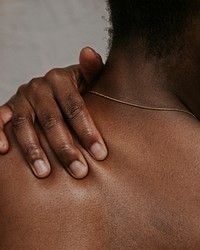 African woman touching shoulder photo