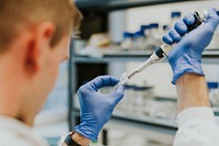 Scientist collecting sample using auto pipette