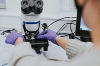 Scientist putting sample on microscope