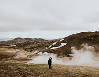 Aesthetic landscape background, man standing with smoke