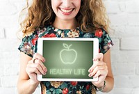 Smiling woman holding tablet.