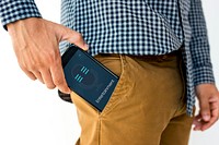 Hand holding network graphic overlay digital device in trouser pocket
