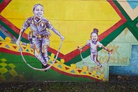                         Murals on a long wall next to the North District police station in the Liberty City neighborhood of Miami, Florida                        