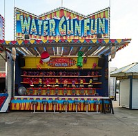                         Carnival-style shooting-gallery game booth like this one in which the guns are water pistols, at the vintage Old Town Kissimmee amusement park, built in the 1980s, in Kissimmee, Florida                        