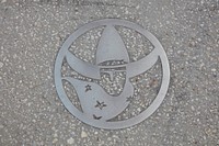                         Sidewalk art acknowledging the city's historic cowboy heritage in downtown Kissimmee, Florida, an old orange-growing and packing town south of Orlando that has grown into the home of several theme parks and other tourist attractions                        