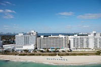                         Aerial view of a lavish seaside condominum apartment building in Miami Beach, a bony-finger-like barrier island separated by Biscayne Bay from Miami and other South Florida cities                        