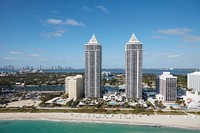                         Aerial view of twin condominium towers in Miami Beach, a bony-finger-like barrier island separated by Biscayne Bay from Miami and other South Florida cities                        