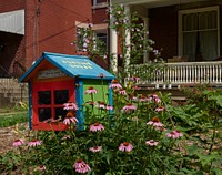                         A "little free library," a birdhouse-shaped receptacle where passersby are encouraged to take or give books, contains the message "justice house" ourside a real, full-sized residence in Lexington, Kentucky                        