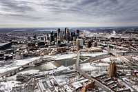                         View from the north of Minneapolis, which--along with neighboring St. Paul--is one of Minnesota's famous "Twin Cities." In addition to the skyline, the focus of this image is the winding Third Avenue, which crosses the Mississippi River on its way downtown                        