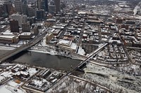                         Wintertime aerial view of downtown Minneapolis, which--along with neighboring St. Paul--is one of Minnesota's famous "Twin Cities." The huge gray building is U.S. Bank Stadium, home of the National Football League's Minnesota Vikings                        