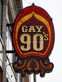                         Sign for the Gay '90s, a gay bar and dance club in downtown Minneapolis, which--along with neighboring St. Paul--is one of Minnesota's famous "Twin Cities"                        