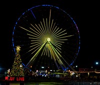                        The signature "United We Stand" Christmas tree, next to the attraction's giant Ferris wheel in Branson, Missouri, once an obscure Ozark Mountain town formed in 1912 and named after Reuben Branson, a local general-store owner, and turned into a large-scale entertainment destination featuring venues starring likable musical stars, comedians, and the like                        