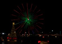                         The signature "United We Stand" Christmas tree, next to the attraction's giant Ferris wheel in Branson, Missouri, once an obscure Ozark Mountain town formed in 1912 and named after Reuben Branson, a local general-store owner, and turned into a large-scale entertainment destination featuring venues starring likable musical stars, comedians, and the like                        