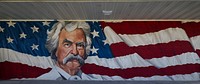                         A surprisingly elegant mural depicting Mark Twain on the facade of a gas station in Hannibal, a city along the Mississippi River in northeast Missouri, so famous as the boyhood home of the legendary writer and wit, later called "the Father of American Literature" by fellow author William Faulkner, where images, signs, and stories of Twain, born Samuel Langhorne Clemens, can be found on what seems like every block in town                        