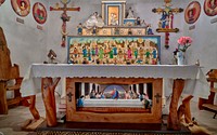                        Altar of the Santo Nino de Atocha Chapel, built in 1857 in Chimayo, a New Mexico village on the "High Road" through the Sangre de Cristo mountains to and from the capital city of Santa Fe and the art and shopping mecca of Taos                        