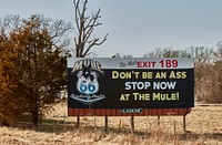                         This cheeky billboard advertising the old Mule Trading Post, a former stop for souvenirs along a surviving section of the old, two-lane U.S. Route 66 in Rolla, a small city in south-central Missouri, lost its effect in early 2021 when the attraction closed due to the effects of a nationwide (and worldwide) COVID-19 pandemic, which kept potential customers at home or wary of unknown places                        