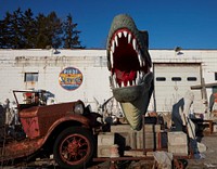                         Gigantic dinosaur-like head and others of what seem like a thousand odds-and-ends collectibles and quirky antiques outside the John E. Piedt & Sons Antique Store in Benton Harbor, Michigan                        