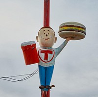                         A fiberglass figure of a teenager, unnamed so far as one can tell, sports a college letterman's sweater emblazoned with an encircled letter T outside the Circle T drive-in restaurant in the central New Mexico town of Belen                        