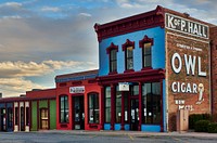                         A classic Owl Cigar advertising sign dominates a block of Socorro, a small city in central New Mexico                        