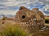                         One of two huge, nearly 200-foot-long rattlesnake creations that snake along the median of the usually dry (and typically New Mexico desert-like) median of University Boulevard along the Mesa del Sol housing development on the south side of Albuquerque, New Mexico                        