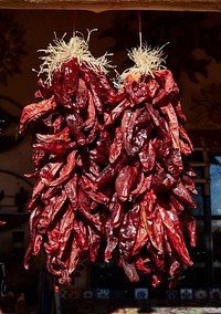                         Real Mexican-style hot peppers, locally called chiles (we say real because many other displays are metal art) are among hundreds of colorful offerings displayed outside the Casa Cristal Pottery home-and-garden roadside store near Velarde in northern New Mexico                        