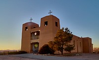                         The Sacred Heart Catholic Mission Church, last restored in 1974 after almost three centuries of existence in various forms at the Nambé Pueblo, settled by one of New Mexico's Tewa-language tribes in the 14th century, 15 miles north of what is now the state capital of Santa Fe, near the southern end of the winding "High Road" to the art and shopping mecca of Taos                        