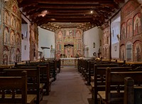                         The sanctuary, filled with hand-painted raredos (altar screens) and other intricate decorations at the El Santuario de Chimayo, a humble shrine in Chimayo, a New Mexico village on the "High Road," a winding route through the Sangre de Cristo mountains to and from the capital city of Santa Fe and the art and shopping mecca of Taos                        