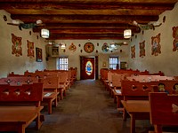                         Carved wooden pews in the sanctuary of at Santo Niño de Atocha Chapel, built in 1857 in Chimayo, a New Mexico village on the "High Road" through the Sangre de Cristo mountains to and from the capital city of Santa Fe and the art and shopping mecca of Taos                        