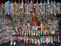                         A shrine outside the El Santuario de Chimayo, a humble but incredibly popular shrine in Chimayo, a New Mexico village on the "High Road," a winding route through the Sangre de Cristo Mountains to and from the capital city of Santa Fe and the art and shopping mecca of Taos                        