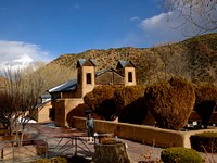                         The El Santuario de Chimayo, a humble but incredibly popular shrine in Chimayo, a New Mexico village on the "High Road," a winding route through the Sangre de Cristo Mountains to and from the capital city of Santa Fe and the art and shopping mecca of Taos                        