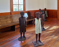                         Artist Woodrow Nash's sculptures of newly emancipated (freed) slave children at the freed-slave-built Antioch Baptist Church on the grounds of Whitney Plantation, one of several surviving antebellum plantation museums, but this one with a fascinating twist, along the "River Road," the Mississippi River, near the tiny town of Wallace, Louisiana                        