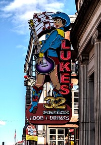                         Neon sign for Luke's 32 Bridge restaurant and bar in the raucous Lower Broadway district of Nashville, the capital city of the mid-South U.S. state of Tennessee                        