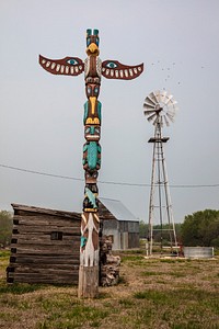                         Rural cabins, a Native American totem pole, and a settlers' windmill at the Cherokee Strip Land Rush Museum in Arkansas City, a small Kansas town near the Oklahoma border                        
