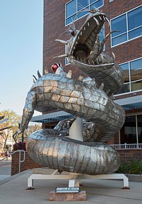                         The fearsome dragon in Dale Lewis's sculpture in downtown Sioux Falls, a city of 180,000 or so people (as of 2021) that is South Dakota's largest city, has an un-fearsome name                        