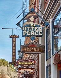                        Array of merchants' signs in Deadwood, a legendary Wild West-era town in the Black Hills of western South Dakota                        
