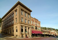                         An old savings-bank building and the adjacent, current (as of 2021) Elks Club lodge in Deadwood, a legendary Wild West-era town in the Black Hills of western South Dakota                        