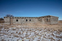                         A very old, multi-door log cabin (perhaps a cowhands' bunkhouse or travellers' rest hostel), near the Scotts Bluff National Monument, a sandstone bluff that was a landmark for westward-heading emigrants on the old Oregon Trail, near Gering in Scotts Bluff County, Nebraska                        